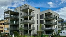 4-storey apartment building, balconies, concrete construction, solar panels, green rooftops