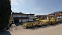 2 story house, white exterior, garage, driveway, hedges, lawn, trees