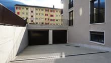Garage area, two garages, concrete parking lot