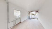 Large room, white walls, tile floor, glass window, radiator, two doors, leading to a parking area