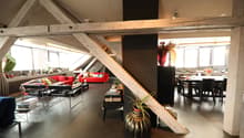 open space, modern furniture, red sofa, black dining table, plants, large windows