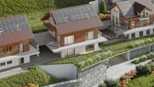 Three houses with solar panels on the roof, balconies, and green roofs