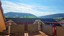 wooden deck, red railing, view of mountains and houses