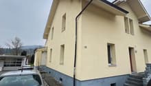 Single family house, yellow paint, windows, door, 2 cars parked