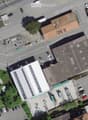 Multiple buildings and a lot of cars parked on an aerial view of the street.