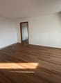 empty room, wooden floor, white walls, wooden door, sunny