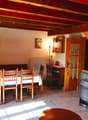 dining room with wooden table and chairs, radiator, wooden stairs, fireplace