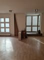 empty room, wooden floor, white walls, two windows, two sets of lights