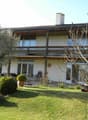 2 story house, white exterior, balcony, garden, lawn, trees, shrubs, lawn mower