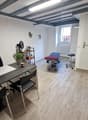 Office room with desk, chairs, treadmill, shelves, picture frame, and a plant