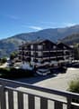 large chalet style building with mountains in the background