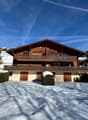 wooden chalet, large balcony, multiple levels, snow covered ground
