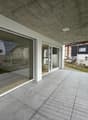 large balcony, glass walls, tiled floor, metal railings, view of mountains
