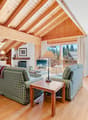 / a large open room with wooden ceilings and furniture