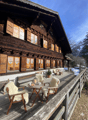 wooden chalet, wooden deck, cozy furniture, glass doors, view of mountains