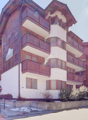 3 story building, wooden exterior, balconies, snow on the ground