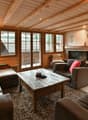 fireplace, wooden ceiling, couches, coffee table, lamps