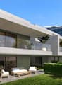 Modern concrete house, glass walls, terrace, outdoor seating, manicured hedges, lawn, trees, mountains in background