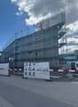 Under construction building, metal scaffolding, large banner with text