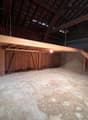 empty room, wooden beams, concrete floor, wooden shelves, wooden stairs