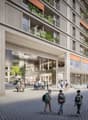 Multi-storey residential building with balconies, entrance with lighting, glass walls, outdoor seating area, paved square
