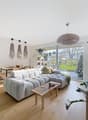 Gray sofa, wooden coffee table, TV, dining table and chairs, potted plants, floor lamps