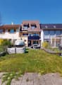 3 story house, brown roof, solar panels, terrace, garden, outdoor seating