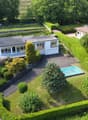 2 story house, white, pool, hedges, driveway