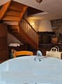 table, chairs, fireplace, cabinets, shelves, staircase
