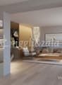 Spacious living room with wooden shelves, wooden floors, beige sofa, coffee table, and a framed artwork on the wall. The room also features a fireplace and decorative elements like plants and vases.