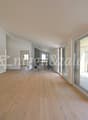 empty room, wooden floor, white walls, large glass doors, balcony