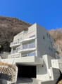 modern apartment building with multiple balconies and underground garage