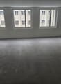 Empty room with 3 windows, concrete floor
