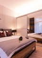 double bed, pillows, blanket, nightstand, lamps, mirror, carpet, wooden flooring