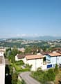 City view, multiple houses, mountain view, trees, greenery