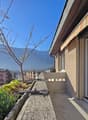 Building with balcony, plants, and a view of mountains