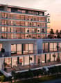 modern apartment, 5 floors, multiple balconies, large windows, outdoor seating area, green landscape