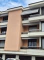 4 story apartment building, multiple balconies, underground garage