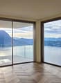 large floor to ceiling windows, wooden floor, balcony with glass railings