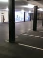 An underground parking lot, concrete floors, metal pillars, parking spots, windows