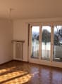 empty room, wooden floor, white walls, sliding glass doors, balcony, radiator