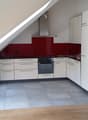 modern kitchen, white cabinets, red wall, gray floor, stainless steel appliances