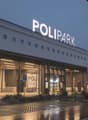 Polipark building with a large sign, multiple circular windows, and a parking area in front