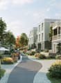 Modern multi-story residential buildings, brick wall facade, balconies, paved walkway, landscaped garden, bicycles parked, green environment