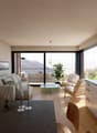 modern living room with large windows, wooden floor, white walls, large couch, coffee table, plants, wooden chairs, table with candles, kitchen with cabinets and countertop