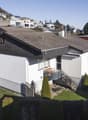 single family house, 2 stories, white walls, gray roof, concrete stairs, balcony with railings