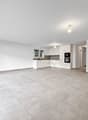 large open room, kitchen, large windows, balcony, tile flooring