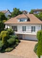 2 story house, brown roof, white walls, balcony, garage, driveway