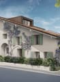 Multi-storey house, beige walls, green shutters, brown roof, climbing plants, paved street