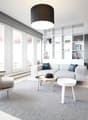 modern living room with white walls, large windows, wooden floor, gray rug, white couch, wooden chair, white coffee table, black pendant light